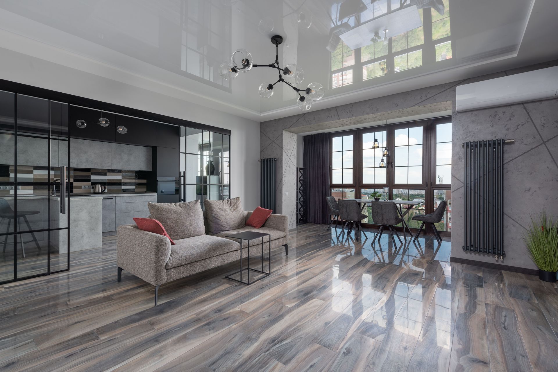Spacious living room with modern furnishings and large windows offering bright natural light.
